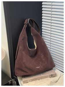 Detail view of coffee brown matte suede tote bag with stylish embossed fashion lettering
