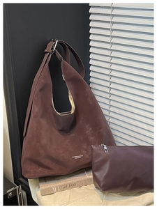 Detail view of large dark brown matte hobo shoulder bag with a matching small zipper pouch