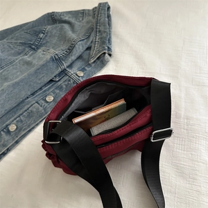 Lightweight burgundy nylon crossbody bag with multi-layer storage for daily essentials