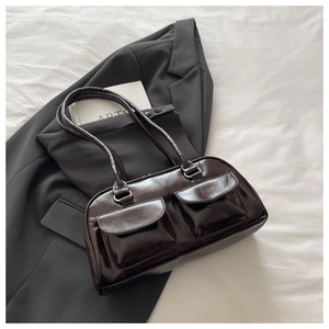 Detail showing deep brown glossy leather underarm bag with double front flap pockets