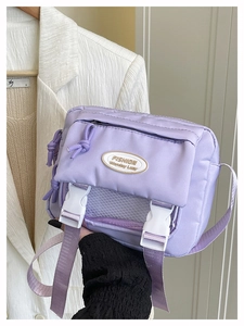 Close-up of light purple crossbody bag with buckle detail and mesh design
