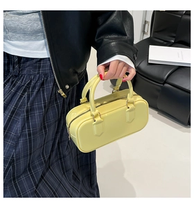 Close-up of pale yellow PVC jelly bag with glossy finish and metal zipper detail