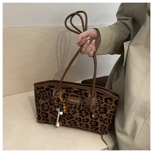 Detail of vintage leopard print suede tote with leather patch and beaded charm
