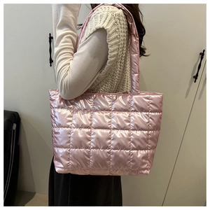 Detailed close-up of pink quilted nylon tote bag featuring a metallic glossy finish