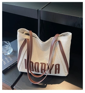 Detail of canvas tote bag with leather straps and Loorya patch in a lifestyle setting