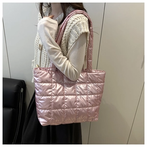 Detailed side view of pink quilted down tote bag with satin finish and wide shoulder straps