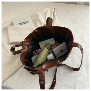 Interior view of large brown tote bag showing storage space for daily essentials