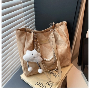 Detail of khaki quilted tote with silver chain, pearl strap and fluffy cloud charm
