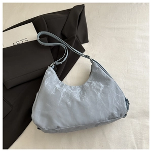Detail of light blue hobo bag with cloud-like marble texture and adjustable strap