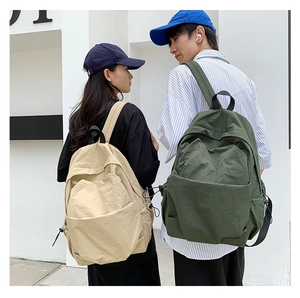 Front view of khaki and olive green nylon backpacks for couples on models