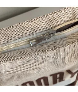 Detail of silver smooth metal zipper and high-quality canvas fabric on tote bag