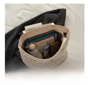 Spacious interior of beige tote bag showing tablet, books, and daily essentials