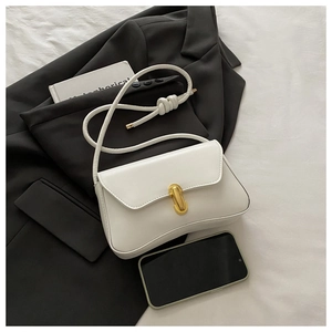 Detailed close-up of cream white PU leather shoulder bag with golden metal twist lock