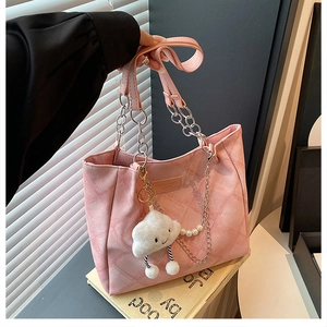 Detailed close-up of pink quilted tote bag featuring a plush cloud charm and silver chain