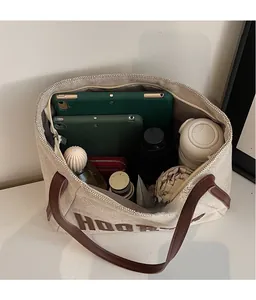 Top view of spacious canvas tote interior showing tablet, umbrella, and water bottle