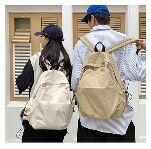 Outdoor back view of large capacity beige and khaki minimalist backpacks for daily commute