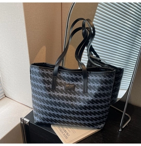 Detail of large tote bag with geometric print and brand patch on premium leather