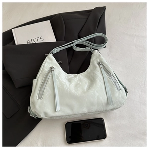 Close-up of marble texture on mint half-moon tote bag with zipper tassels