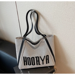 Detail showing high-quality canvas texture and leather handle of HOORYA large tote bag