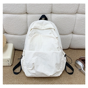 Detail of water-resistant off-white nylon backpack fabric with adjustable drawstring pockets