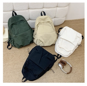 Detail of four colorful minimalist water-resistant nylon backpacks with side pockets
