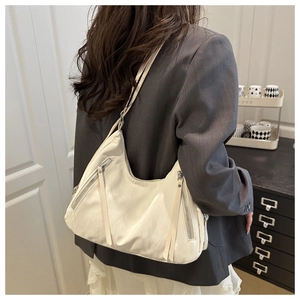Chic white crescent shoulder bag featuring stylish side zippers and long pull straps detail