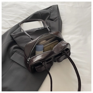 Detail view of the spacious inner compartment of a vintage dark brown shoulder bag