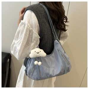 Light blue crescent shoulder bag with silver zippers and a cute cloud plush charm
