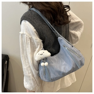 Light blue nylon crescent shoulder bag with white plush cloud pendant detail