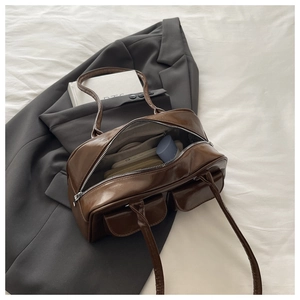 Deep brown oil-wax leather Boston bag showing spacious interior with personal essentials