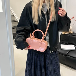 Pink candy-colored PVC jelly pillow bag shown with handles and a crossbody strap