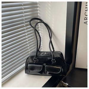 Detail view of the black glossy faux leather shoulder bag with silver double zippers