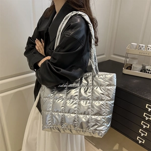 Silver quilted tote bag with metallic finish and spacious shoulder strap for women