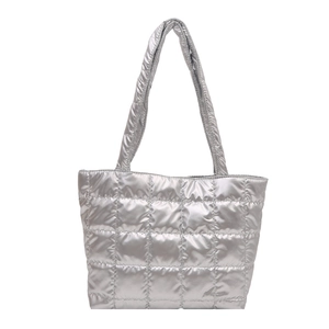 Silver quilted puffer tote bag with metallic finish and padded handles for women