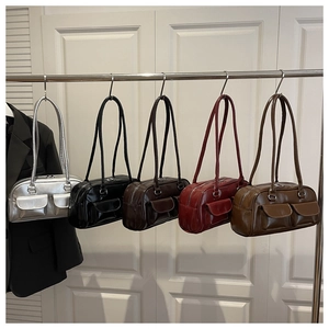 Detail view of stylish Boston bags in five colors hanging on a metal display rack