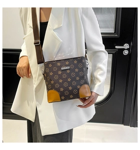 Side view of woman wearing a brown star-patterned PU leather crossbody bag with wide strap