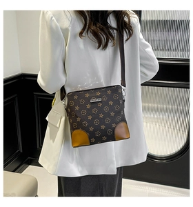 Detail of dark brown leather bucket bag with star patterns and JINGPIN metal logo