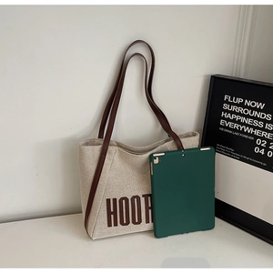 Detailed view of oatmeal canvas tote bag with leather straps and large capacity for a tablet