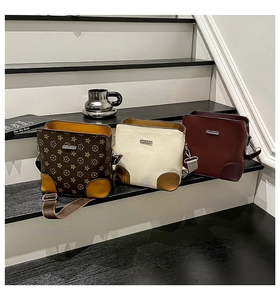 Detailed view of three vintage bucket bags in brown, beige, and burgundy on steps