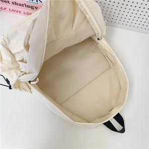 Minimalist cream white large capacity backpack showing spacious main compartment interior