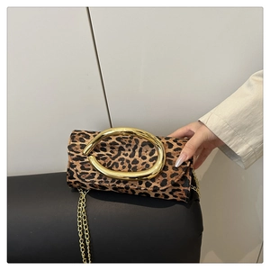 Detail view of leopard print box bag with gold metal handle and chain strap