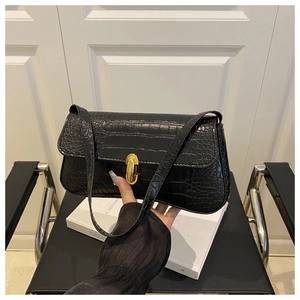Close-up of black crocodile pattern baguette bag with premium gold rectangle twist lock