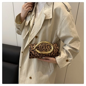 Detail of leopard print crossbody bag with gold irregular buckle and chain strap