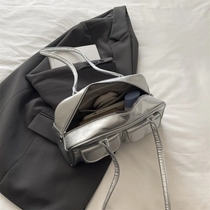 Silver metallic rectangular shoulder bag with dual front flap pockets and top zipper