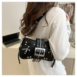 Detail of black punk underarm bag featuring silver rivets and heavy metal hardware