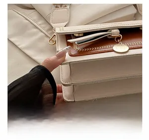 Detailed close-up showing precision stitching and contrast color leather on the bag
