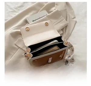 Detail view of the spacious dual-compartment interior for phones and wallets in a small bag