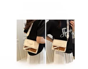 Detail of color-block crossbody bag with bohemian patterned strap for shoulder or chest carry