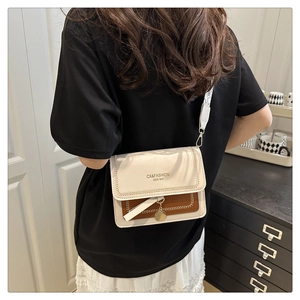 Detailed back view of a chic color-block crossbody bag with V-shaped stitching and gold charm