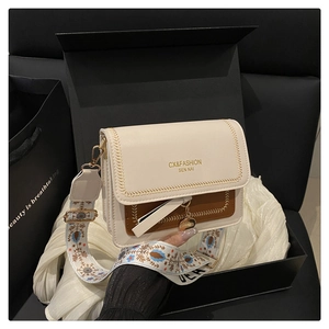 Exquisite gift box packaging of two-tone crossbody bag with chic bohemian strap